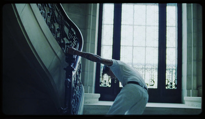 a man climbing up the side of a stair case