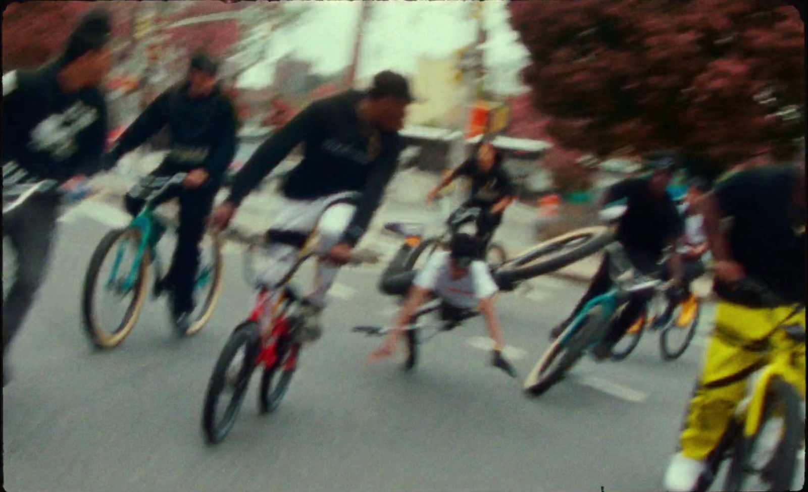 a group of people riding bikes down a street