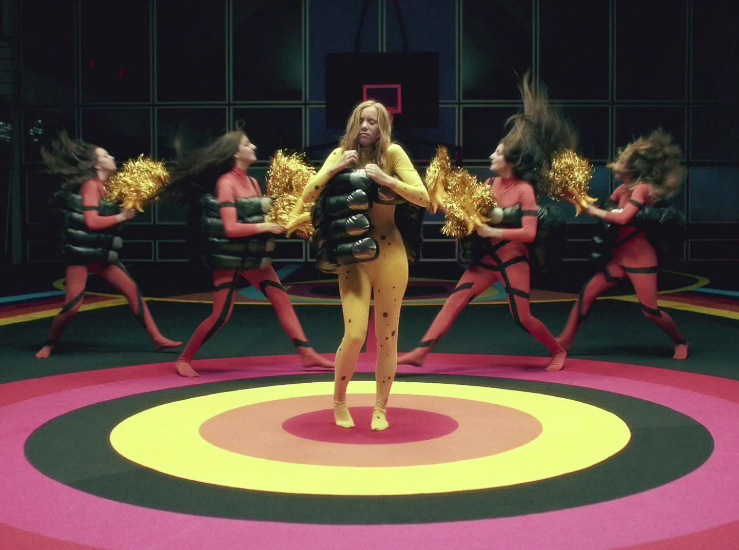 a woman standing in front of a group of dancers