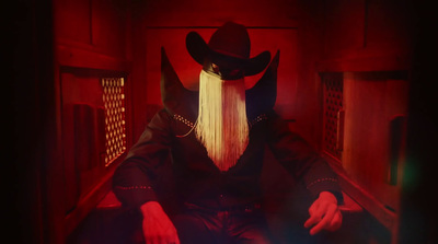 a man with long blonde hair wearing a cowboy hat