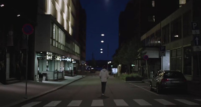 a person walking down a street at night