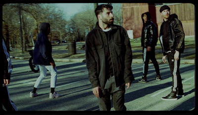 a group of people walking across a street