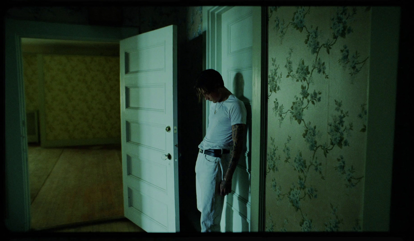 a man standing in front of a door in a room