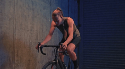 a woman riding a bike on a street