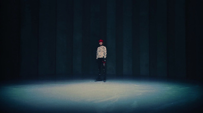 a person standing on a stage in a dark room