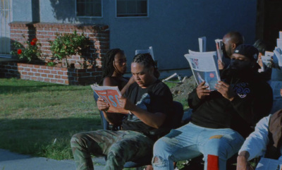 a group of people sitting on top of a lawn chair