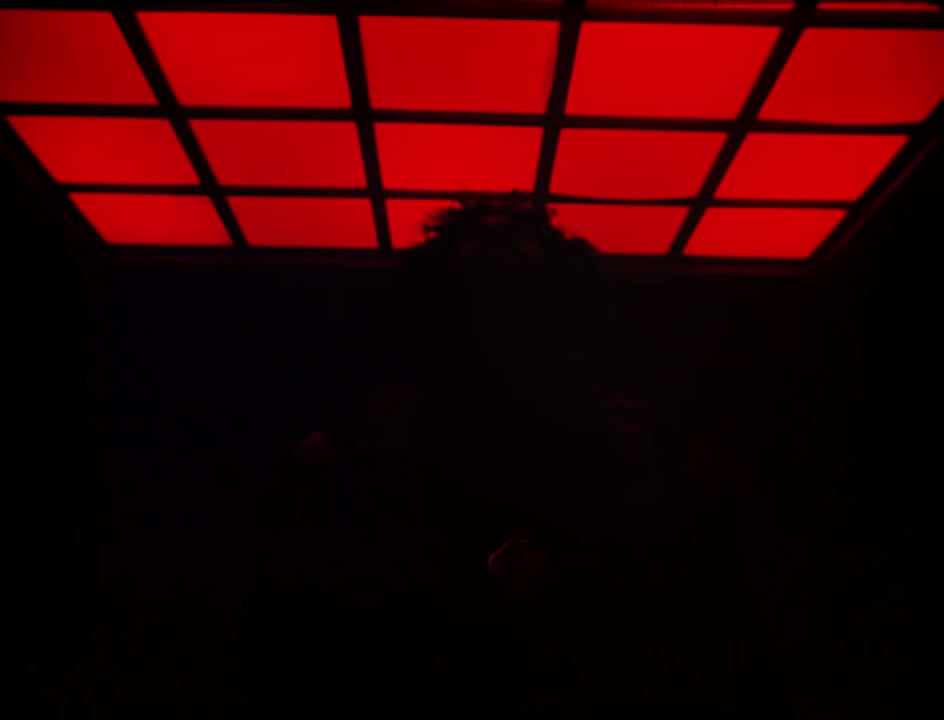 a dark room with a red light in the ceiling