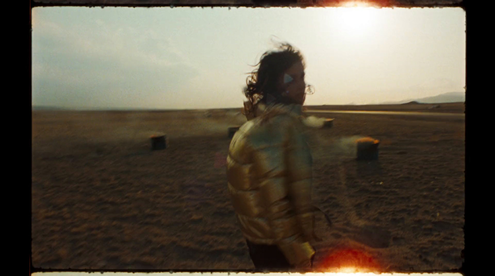 a person standing in a field with a frisbee