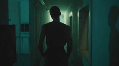 a person standing in a hallway in the dark