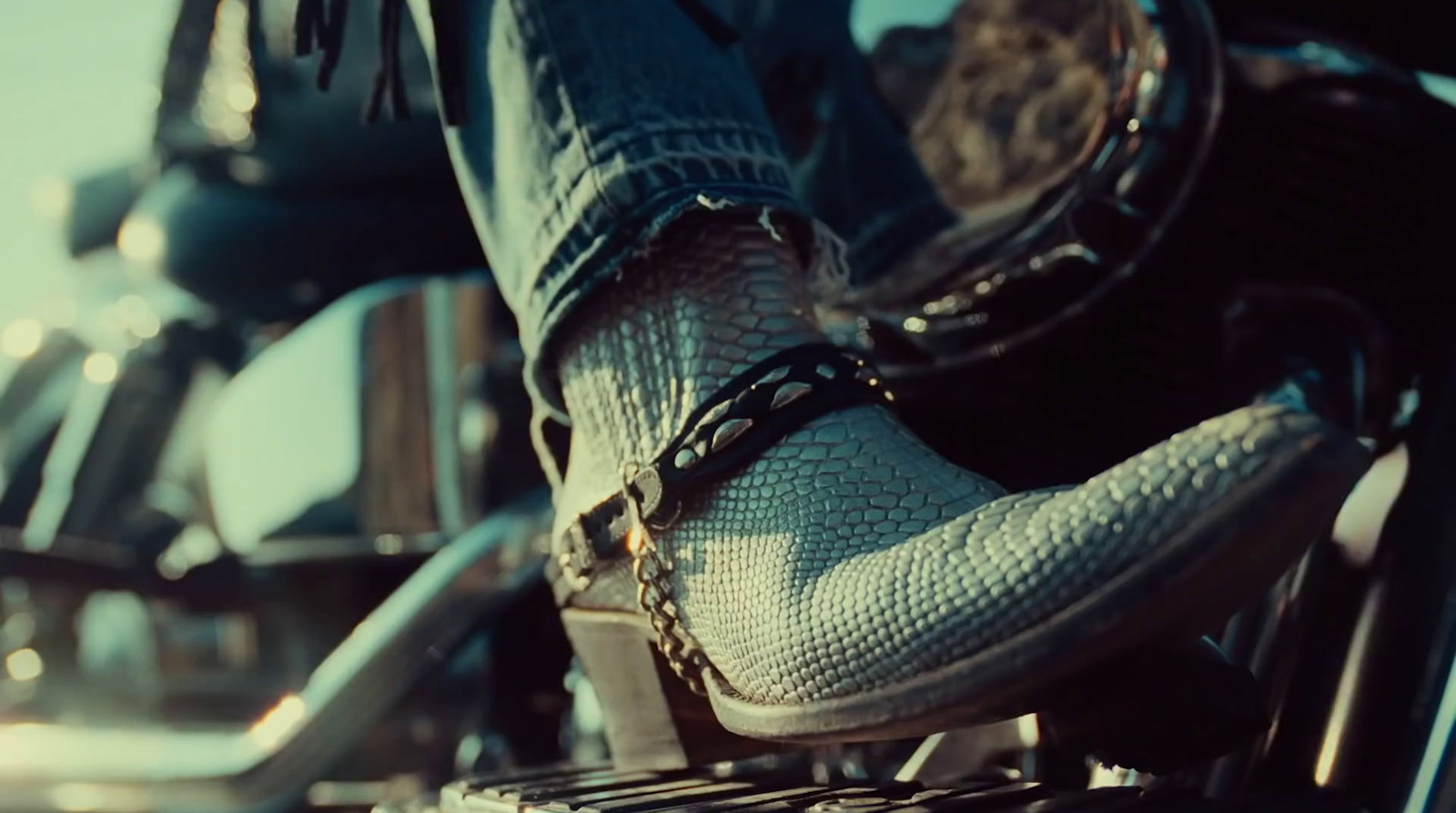 a close up of a person's feet on a motorcycle