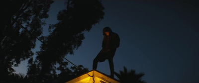 a man standing on top of a roof at night