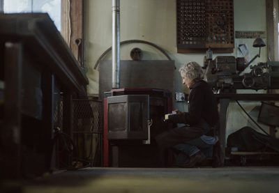 a woman sitting on a stool in a room