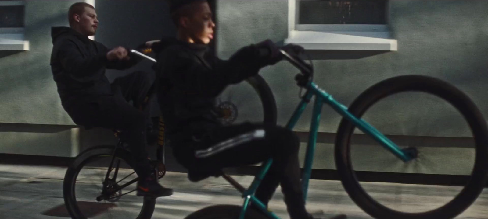 a man riding a bike next to a woman