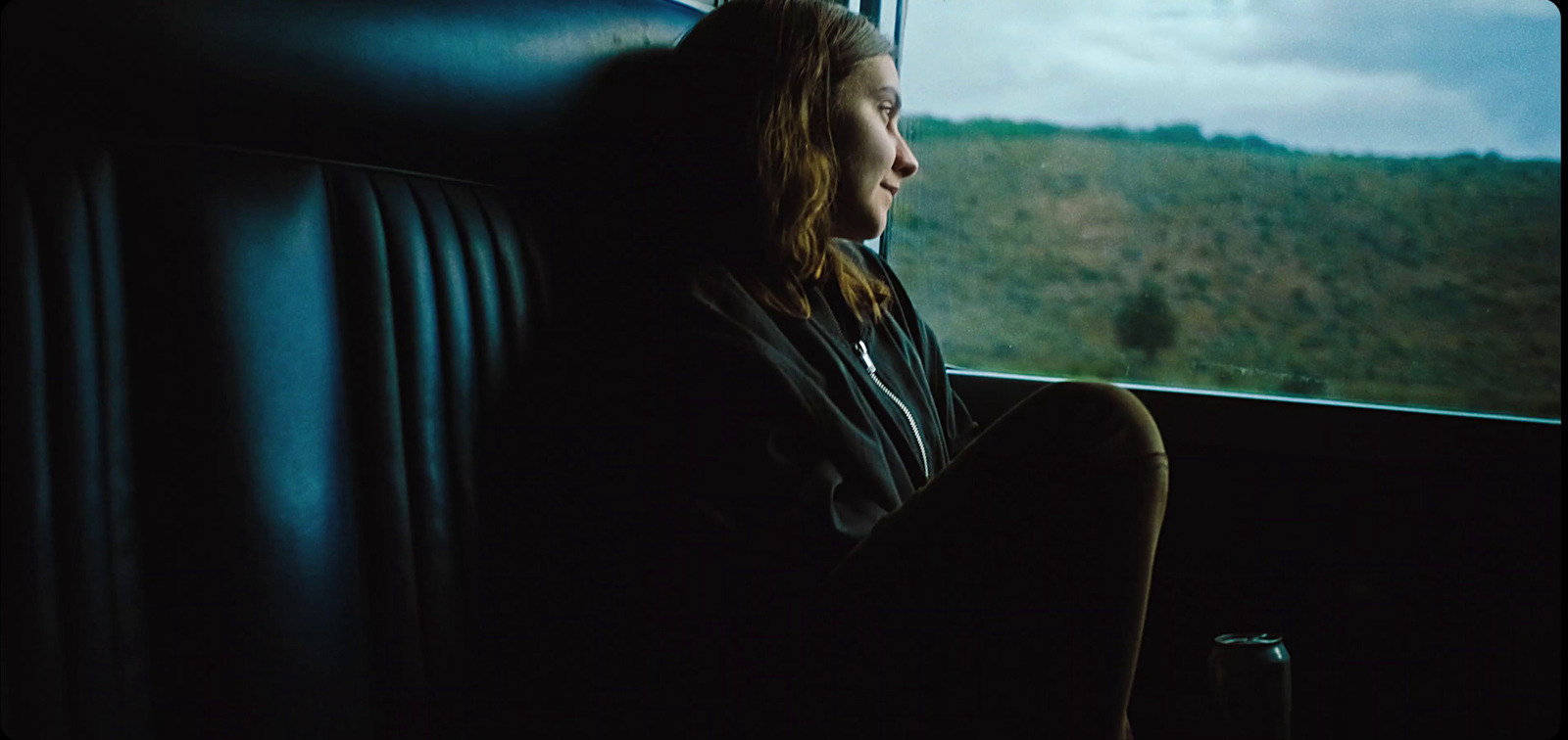 a woman sitting on a train looking out the window