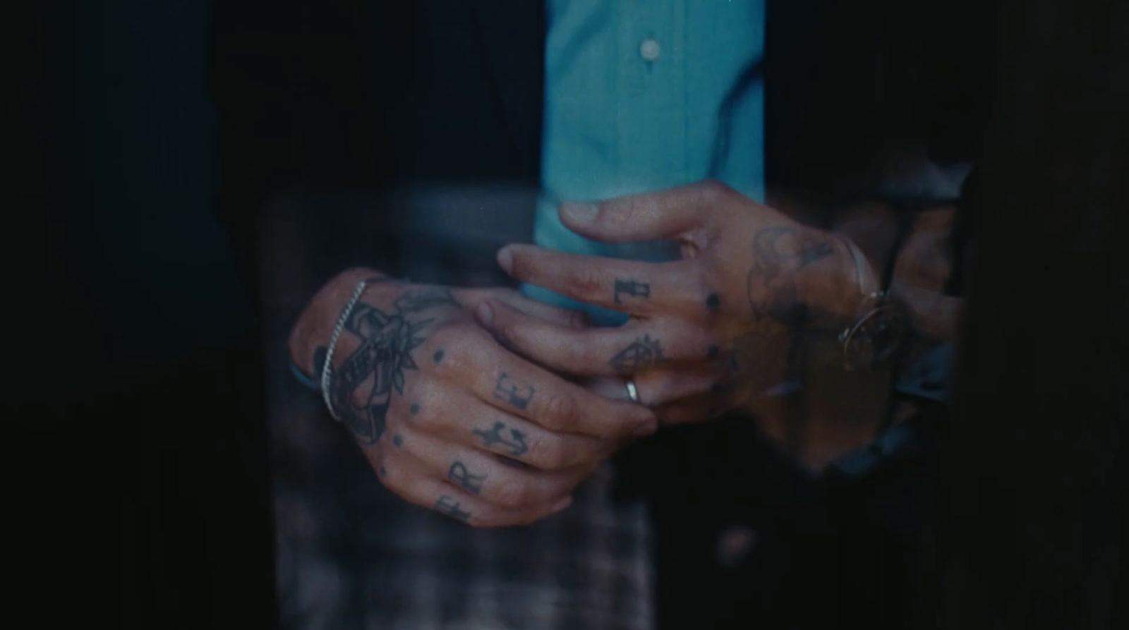 a person with tattoos holding a cell phone