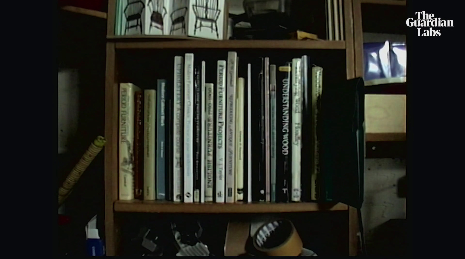 a bookshelf filled with lots of books next to a tv