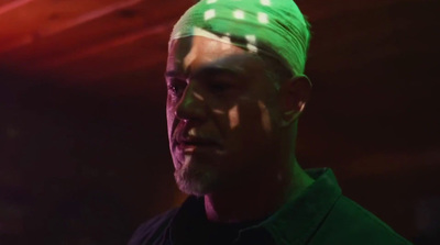 a man with a green bandana on his head