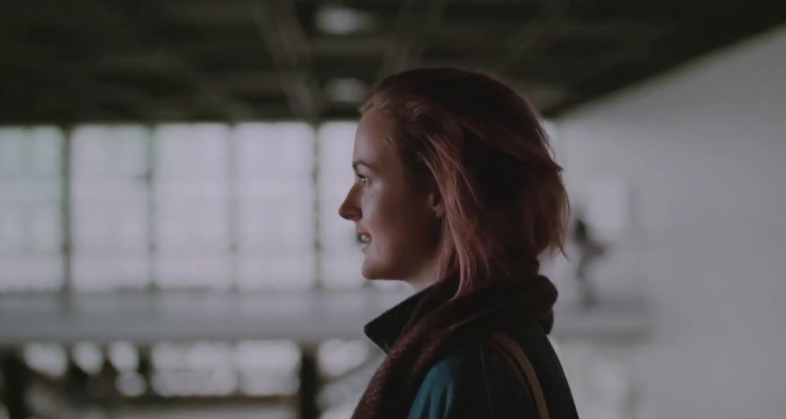 a woman with red hair standing in a building