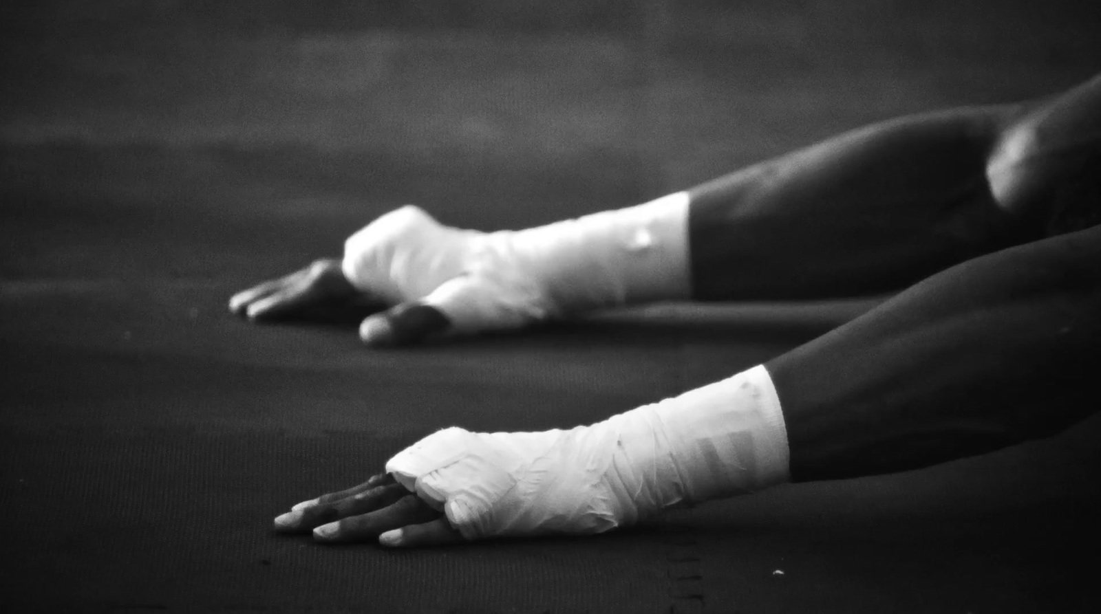 a black and white photo of a person with bandages on their feet