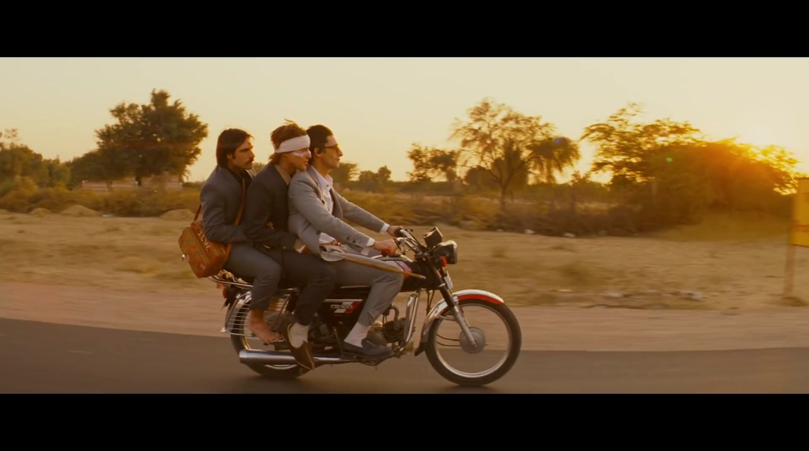 a couple of people riding on the back of a motorcycle