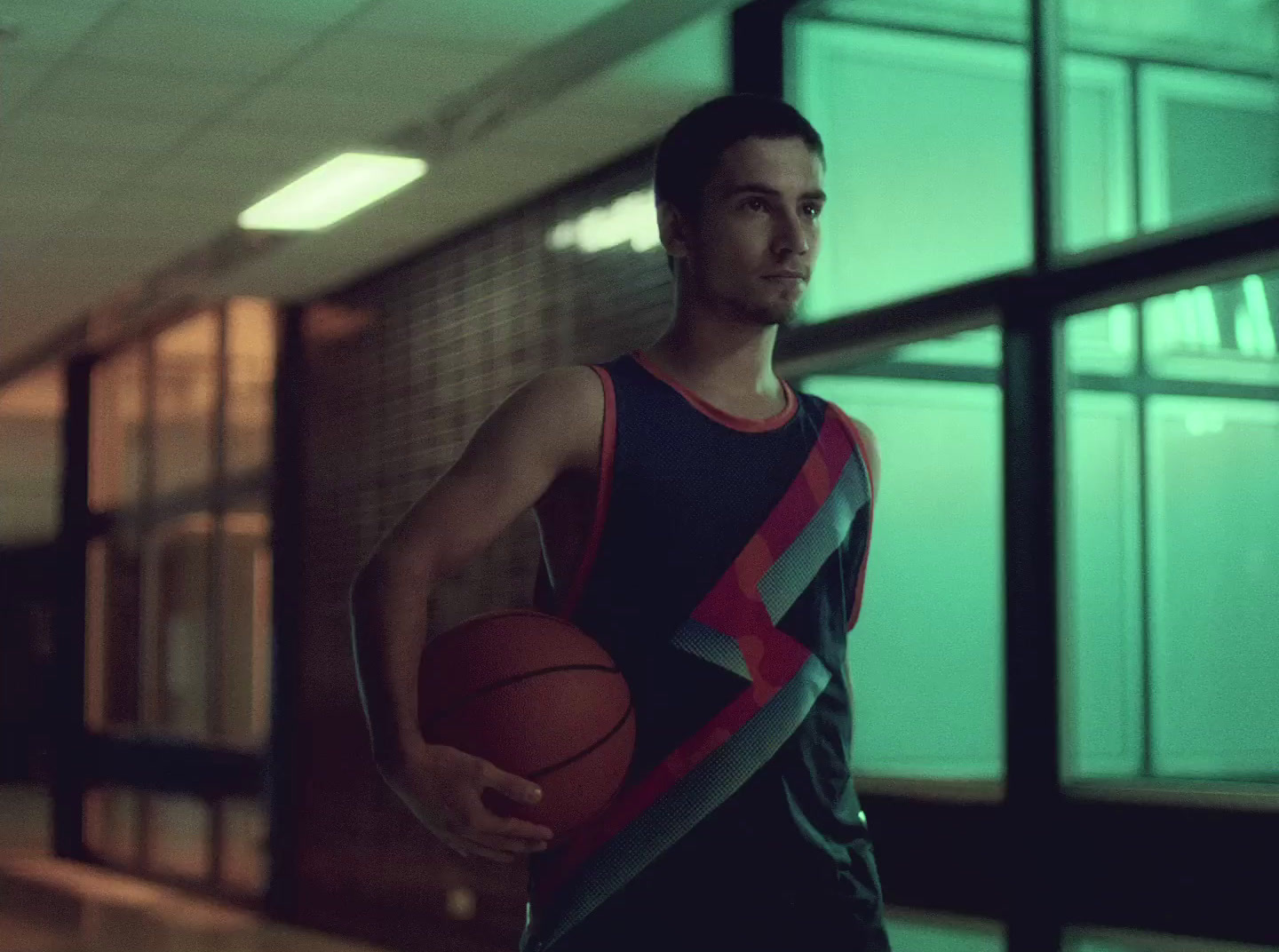 a man holding a basketball in a gym