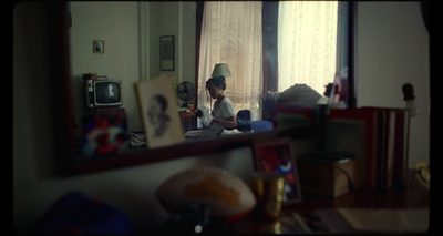 a man sitting on a couch in front of a mirror