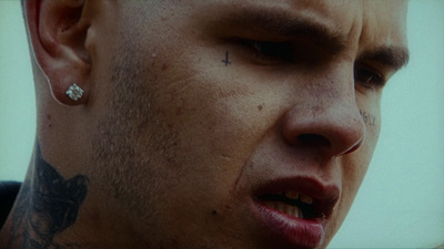 a close up of a person with a piercing on his nose