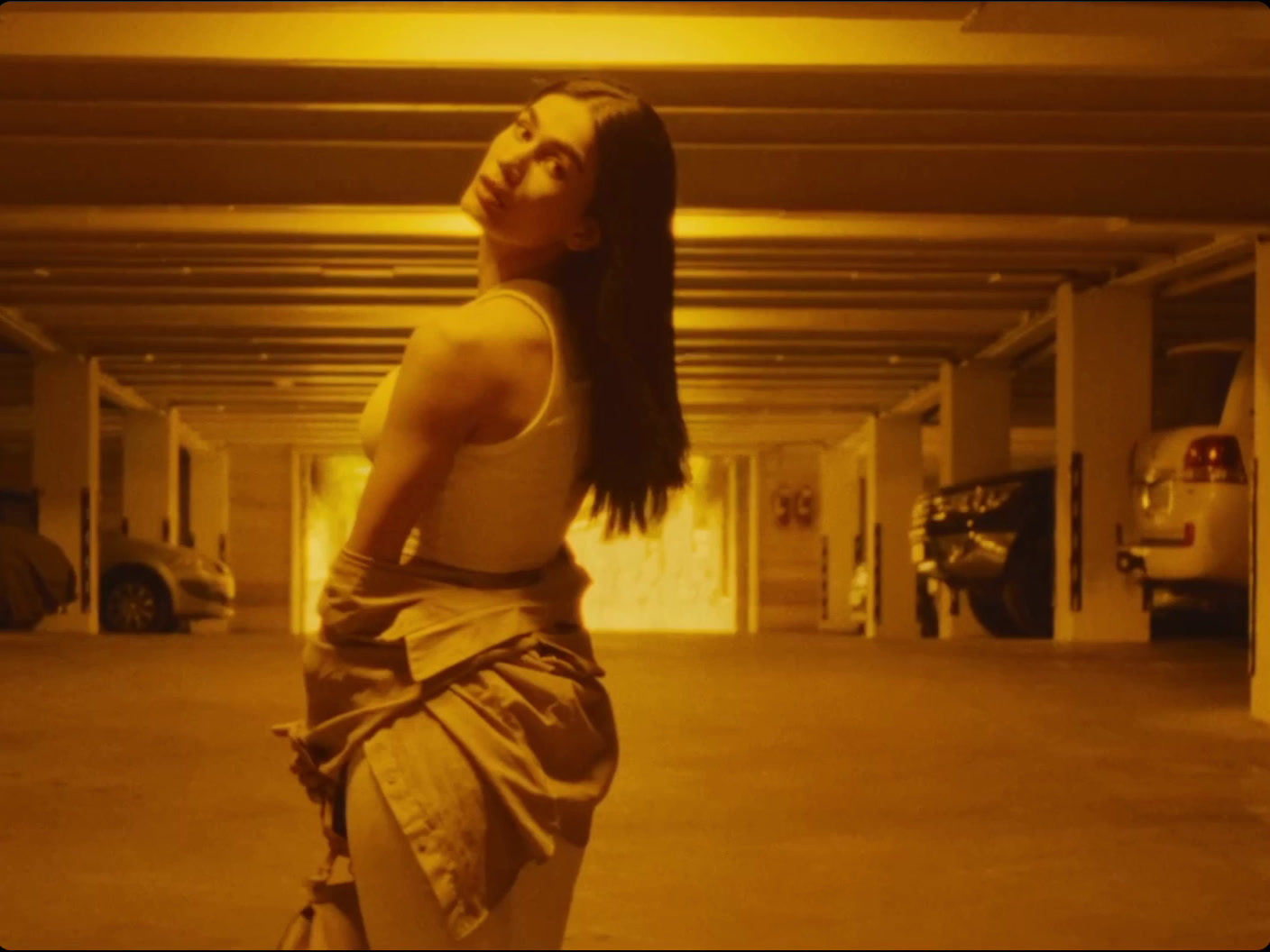 a woman is standing in a parking garage