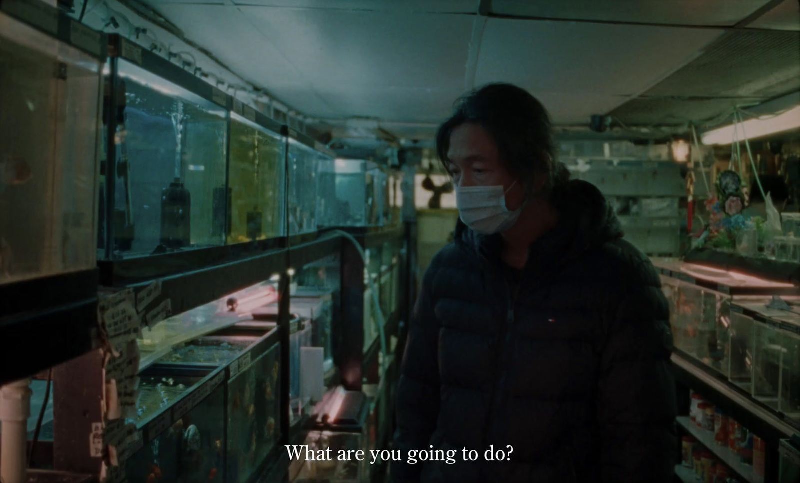 a man wearing a face mask standing in a room