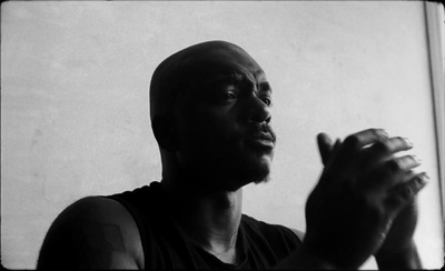 a black and white photo of a man holding something