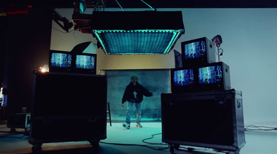 a man standing in front of a bunch of televisions