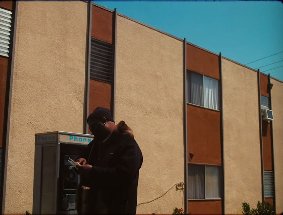 a person standing in front of a building using a cell phone