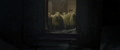 a group of sheep standing in a dark room