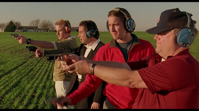 a group of men standing next to each other holding guns