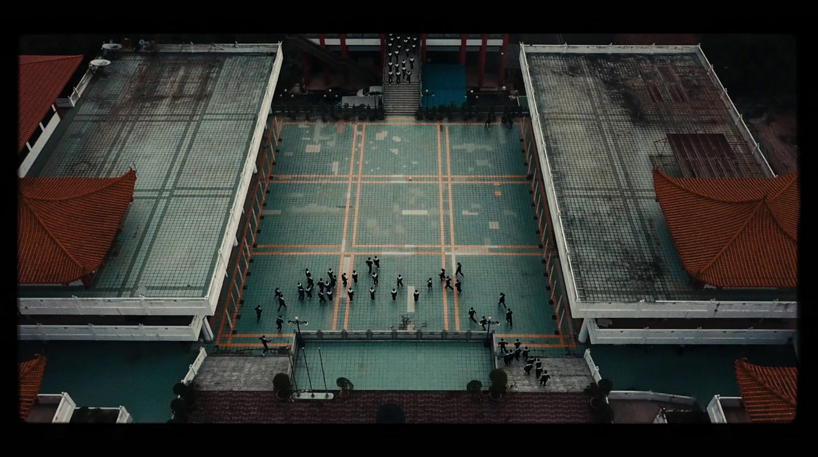 a group of people standing on top of a tennis court