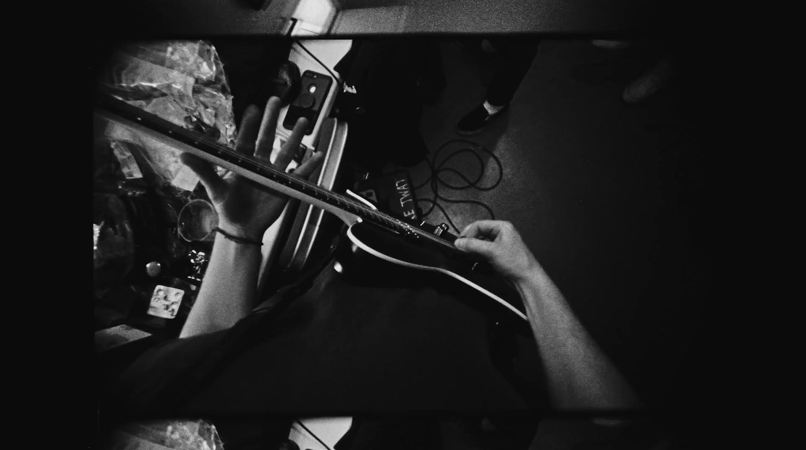 a black and white photo of a person holding a violin