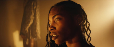 a woman with dreadlocks standing in a room