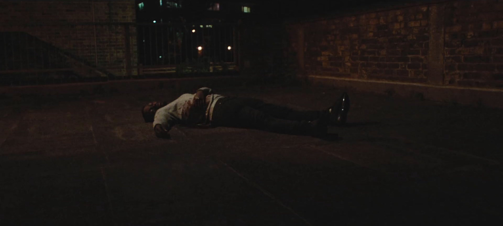 a person laying on the ground in the dark