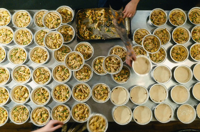 a table topped with lots of cups filled with food