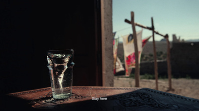 a glass of water sitting on top of a table