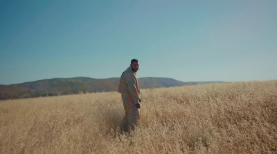 a man standing in a field of tall grass