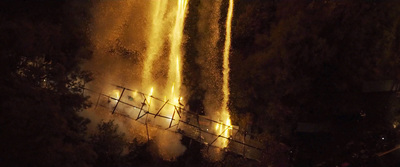 a large waterfall is lit up at night