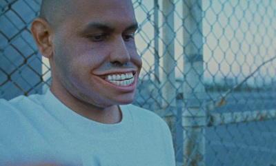 a man standing in front of a chain link fence