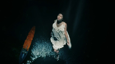 a woman in a white dress holding a surfboard