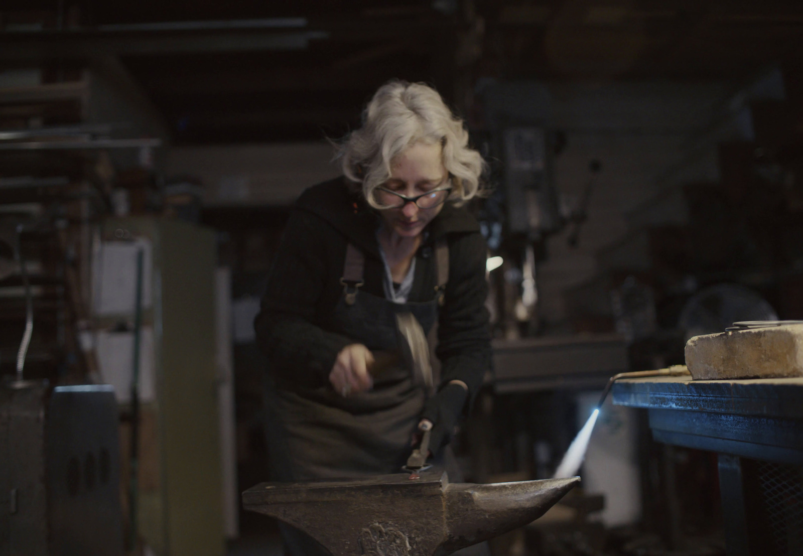 a woman working on a piece of wood