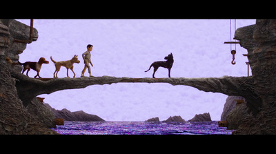 a man walking across a bridge with three dogs