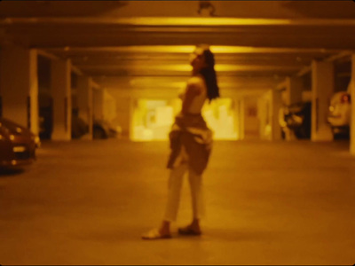 a woman is standing in a parking garage