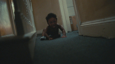 a young child crawling on the floor in a hallway