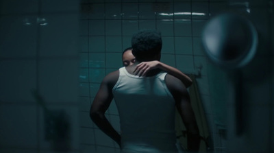 a man standing in front of a mirror in a bathroom