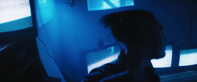 a person standing in front of a tv in a dark room